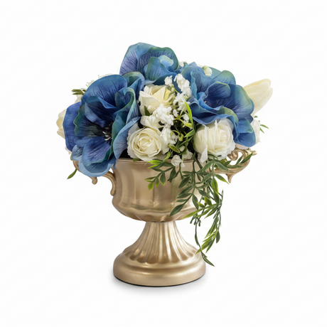 Floral arrangement in a gold urn on a white background
