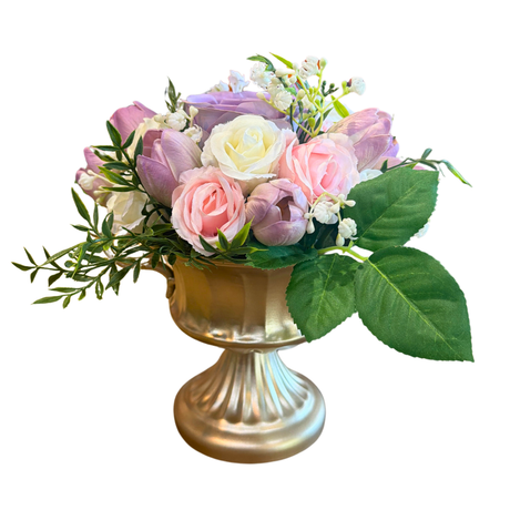 Floral arrangement in a gold urn on a white background